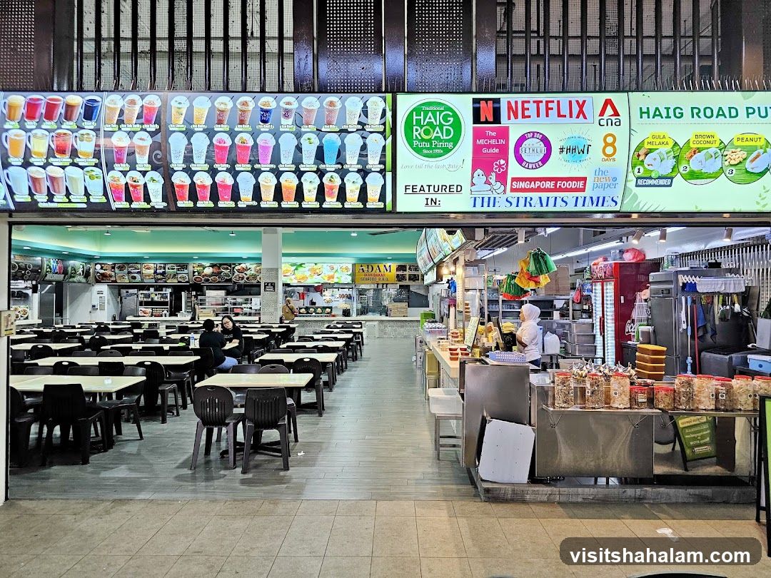 Food court with various food stalls and seating area