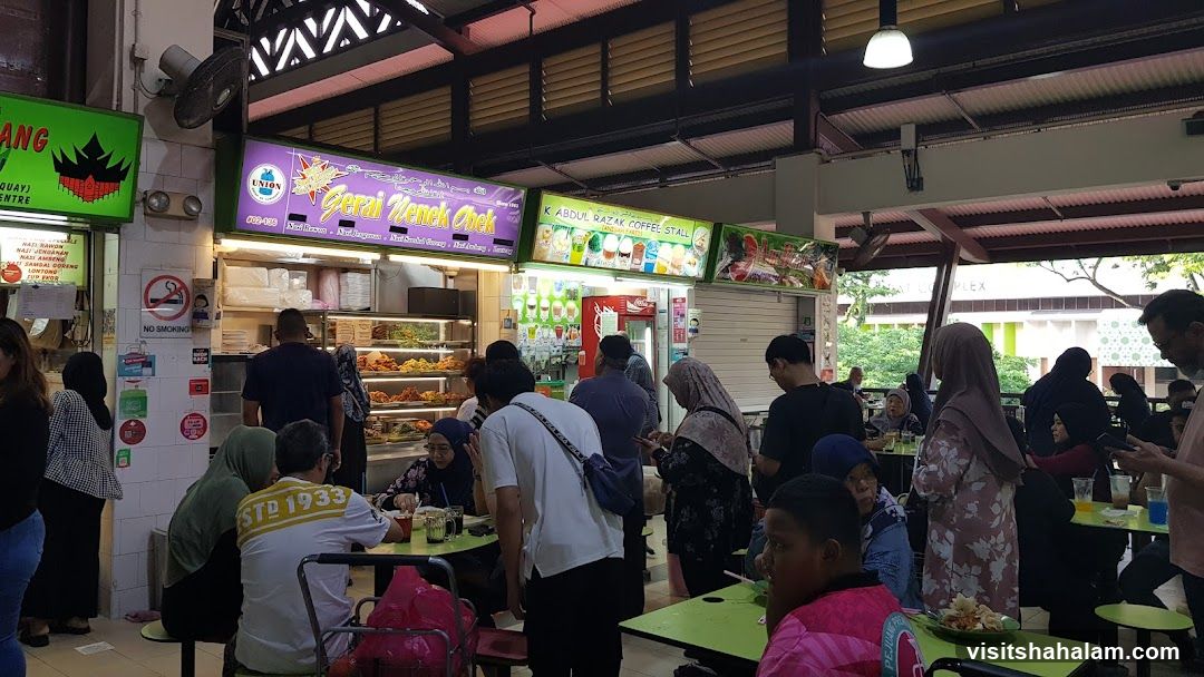 Food court with various stalls and patrons