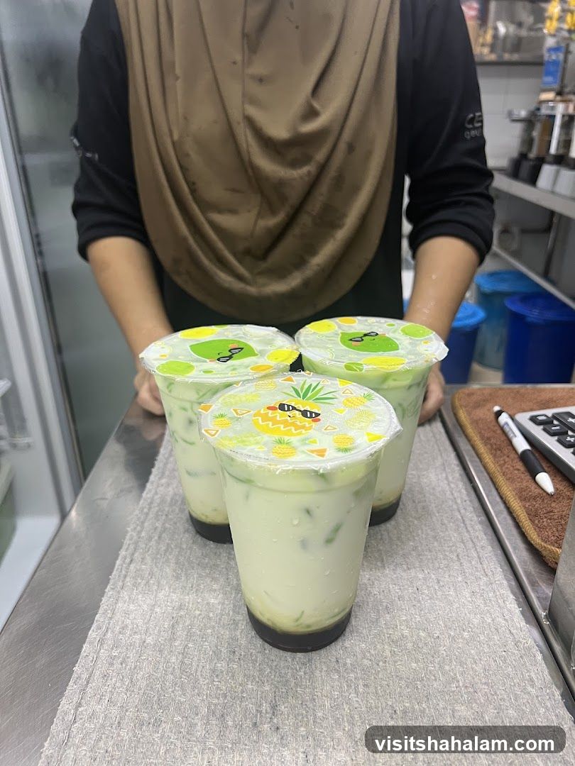 Three drinks with cartoon pineapple and frog lids