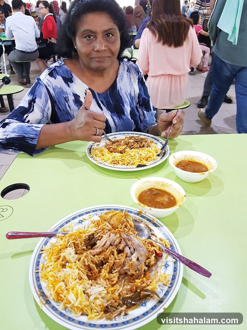 Woman giving a thumbs up with biryani