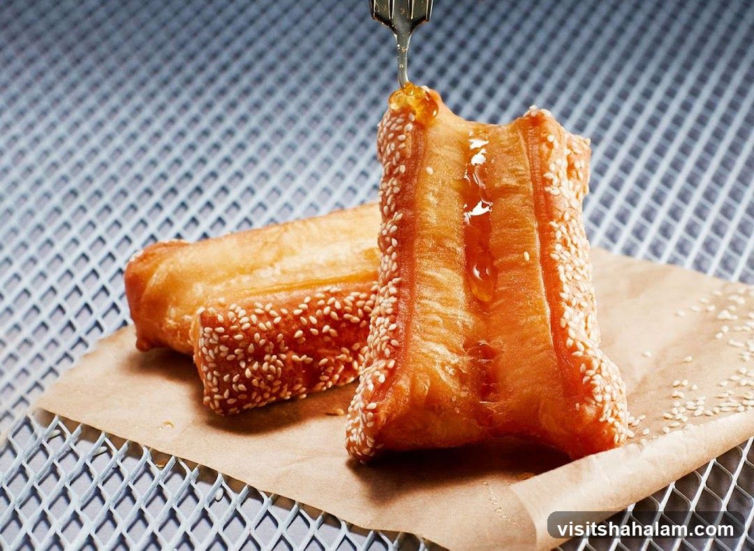 Fried Dough Sticks with Sesame Seeds and Honey