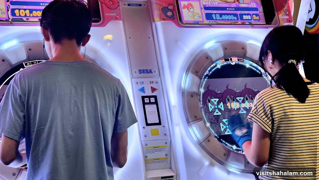 People Playing Arcade Game