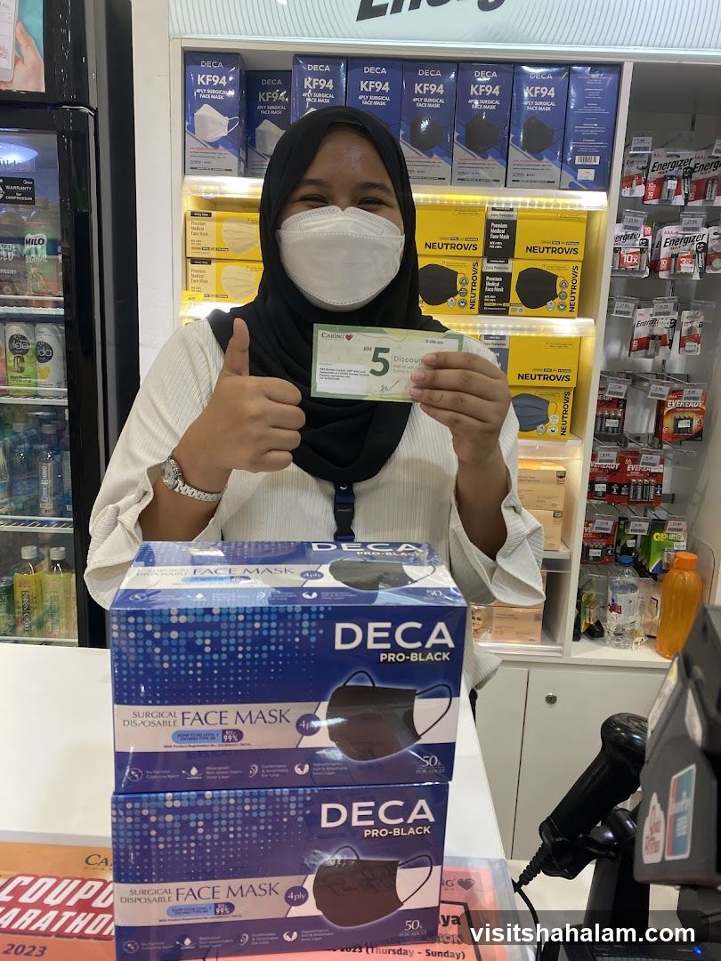 Woman holding a discount coupon and showing boxes of face masks