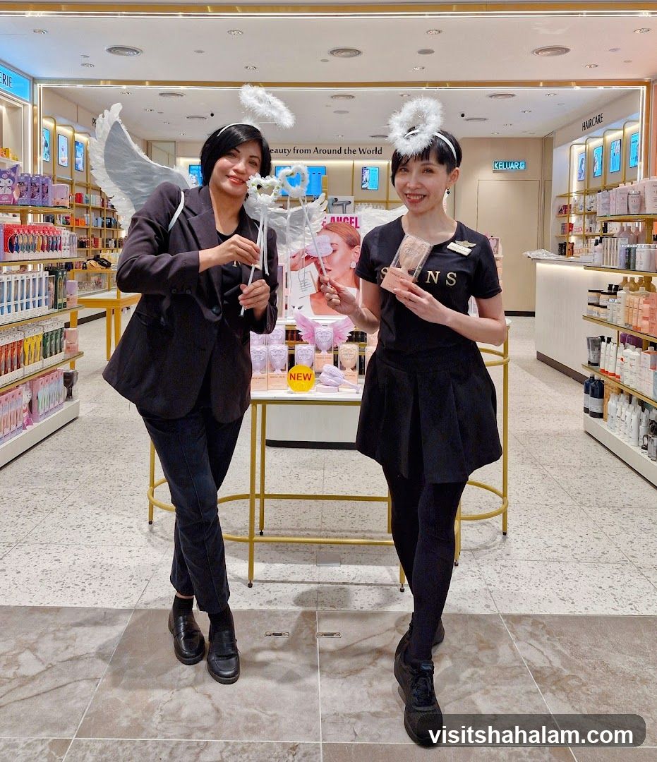 Two women in angel costumes in a store
