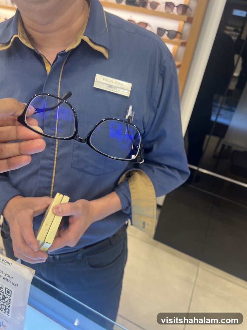 Optician holding glasses