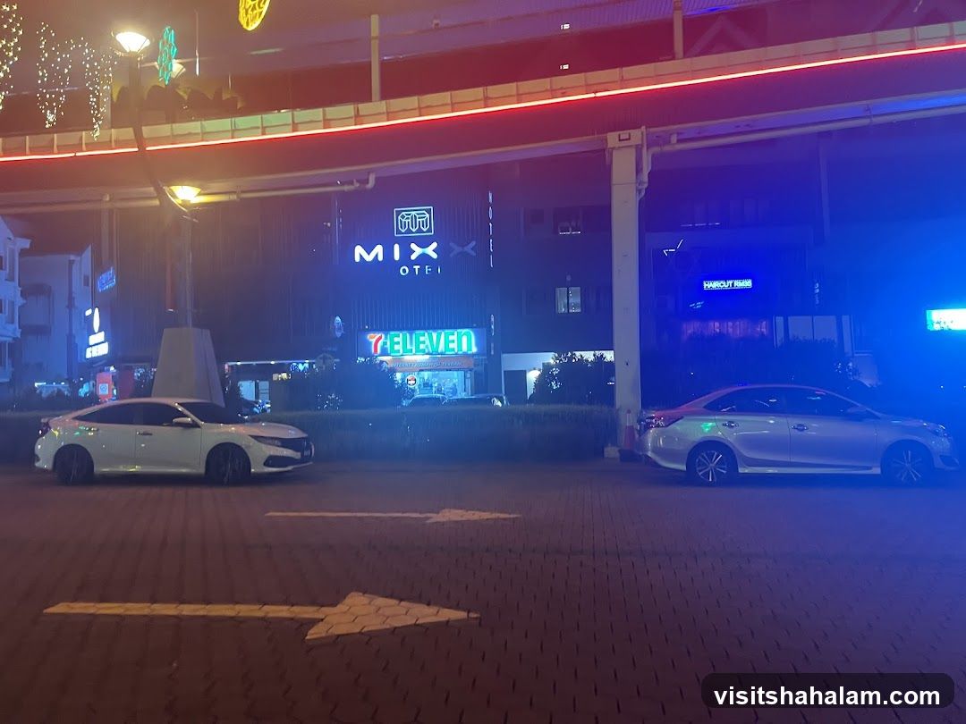 Nighttime street scene with businesses and cars