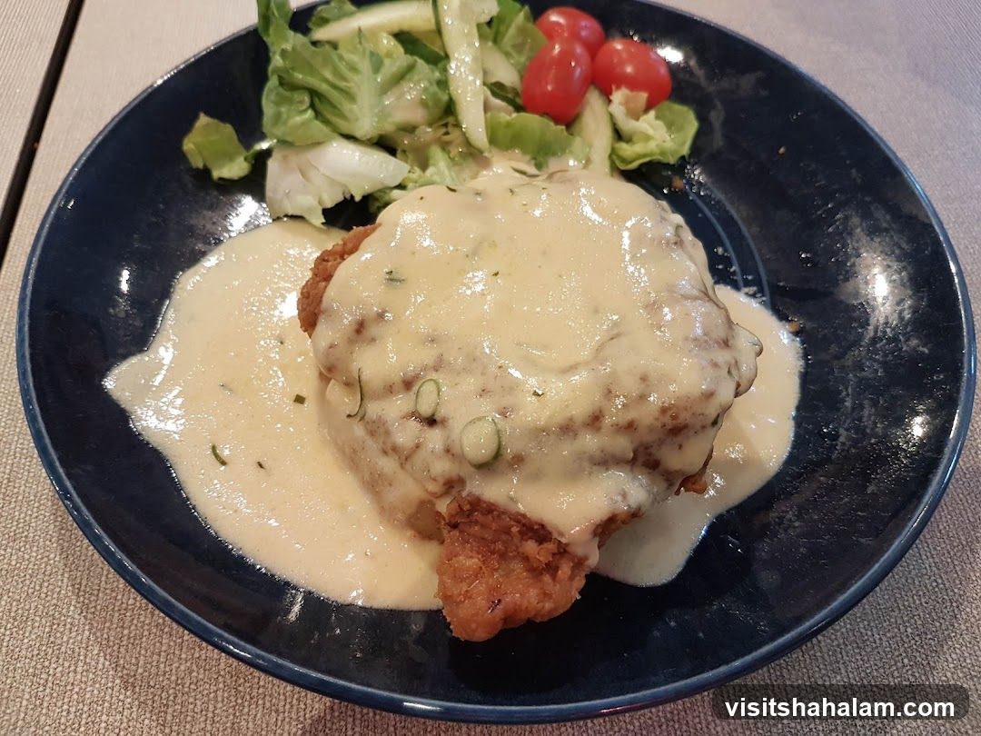 Chicken dish with sauce and salad