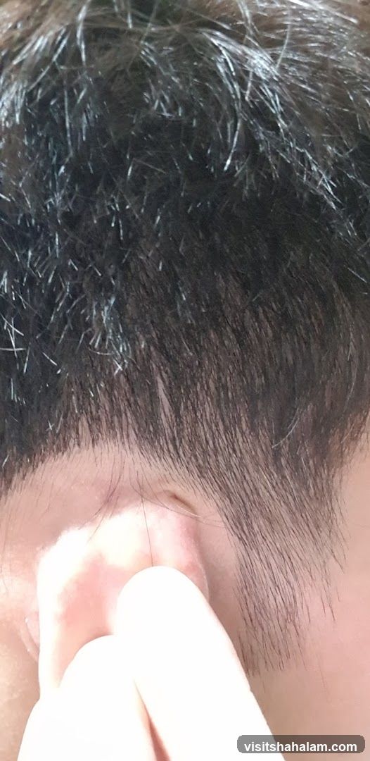 Close-up of a person's ear and hair