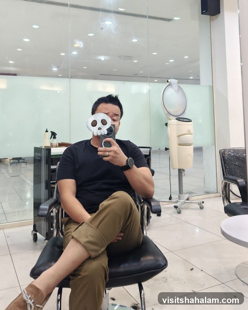 Man taking a selfie in a salon chair