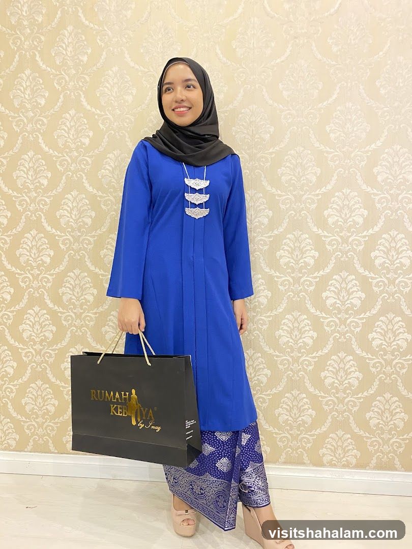 Woman in Blue Kebaya Holding Shopping Bag