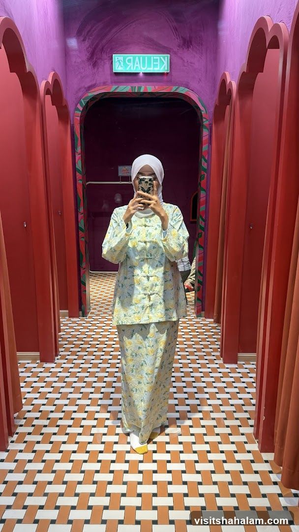 Woman in floral outfit taking a mirror selfie