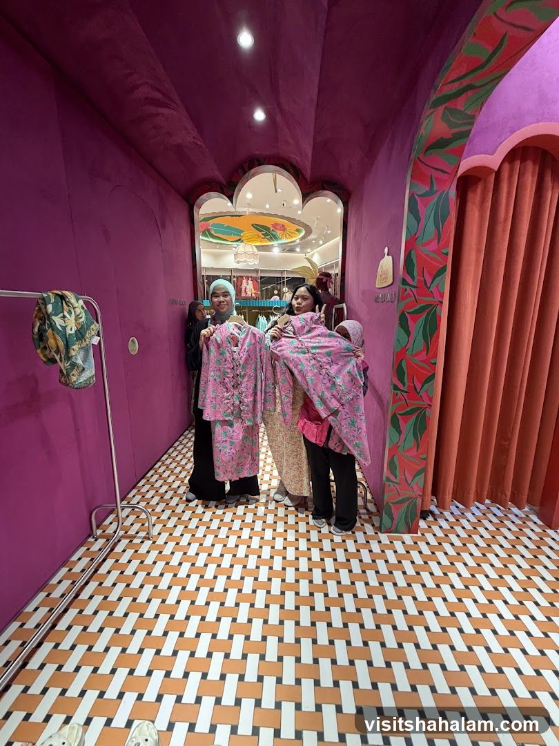Women holding up patterned clothing