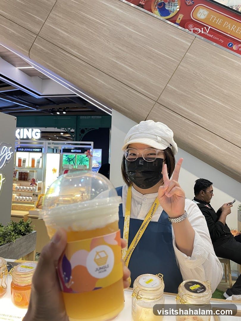Woman holding a drink at a stall