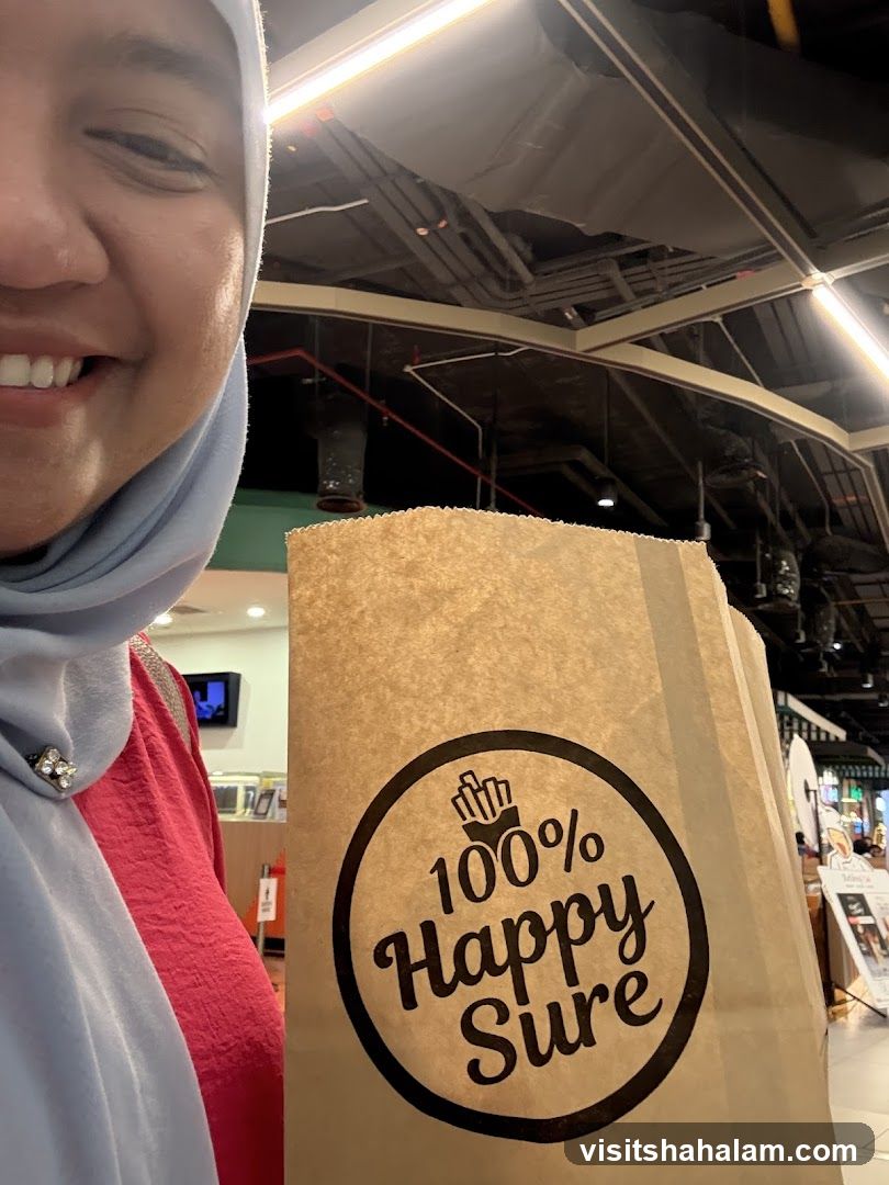 Person holding a paper bag with a logo
