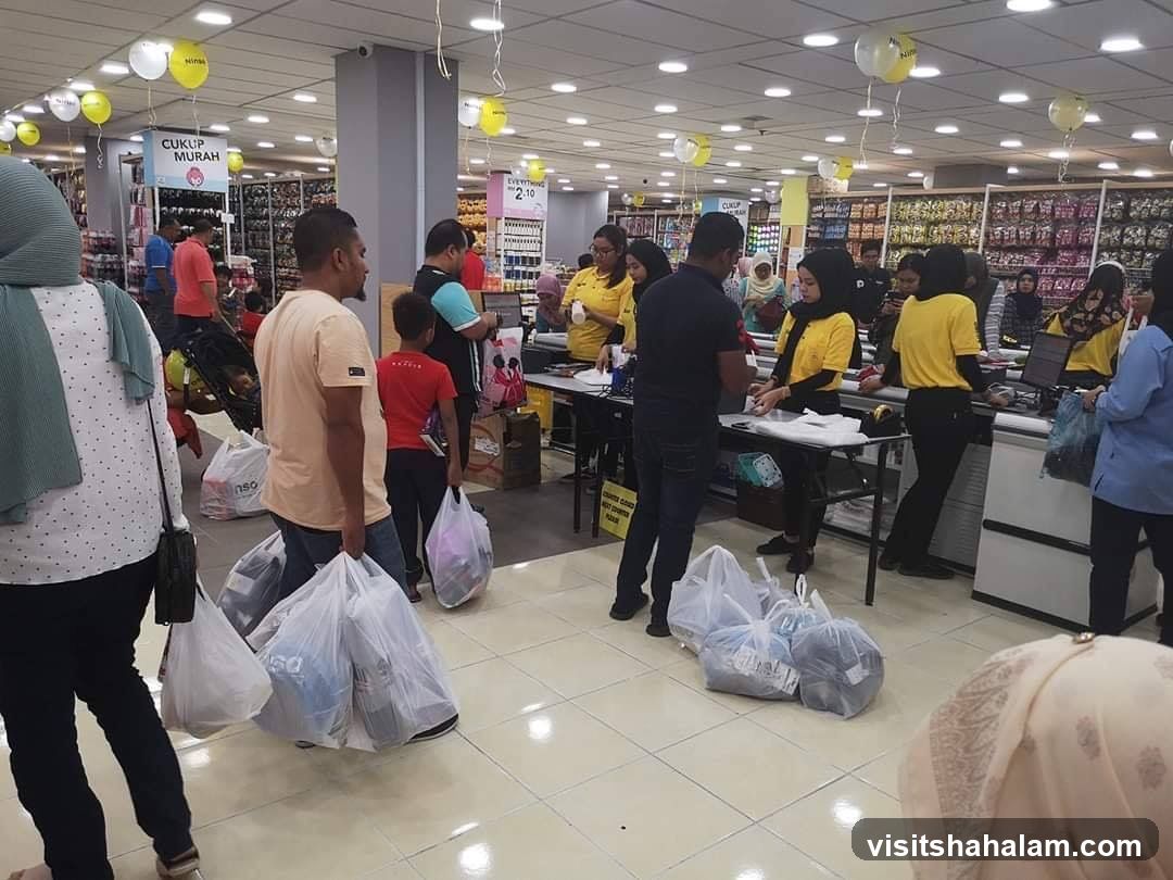 Busy store with shoppers and staff at checkout