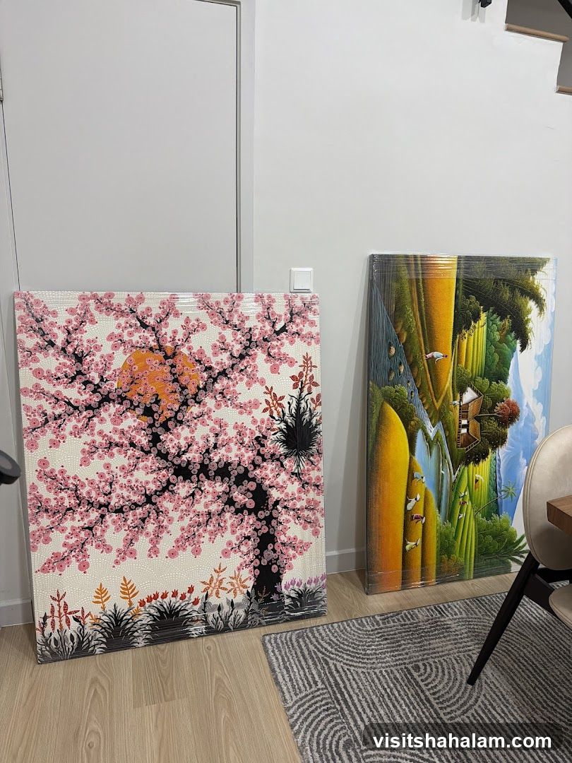 Two paintings leaning against a wall
