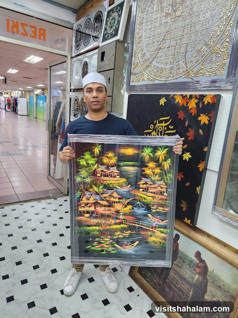Man holding a framed painting