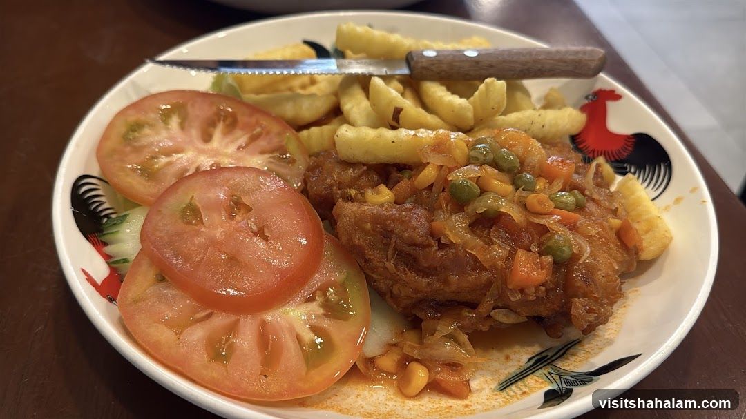 Chicken dish with fries and tomatoes
