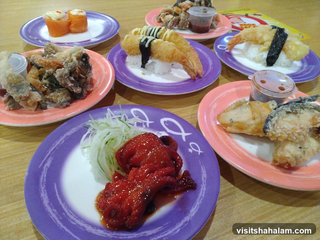 Plates of Sushi and Fried Food
