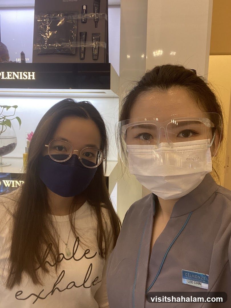 Two women wearing masks and face shields