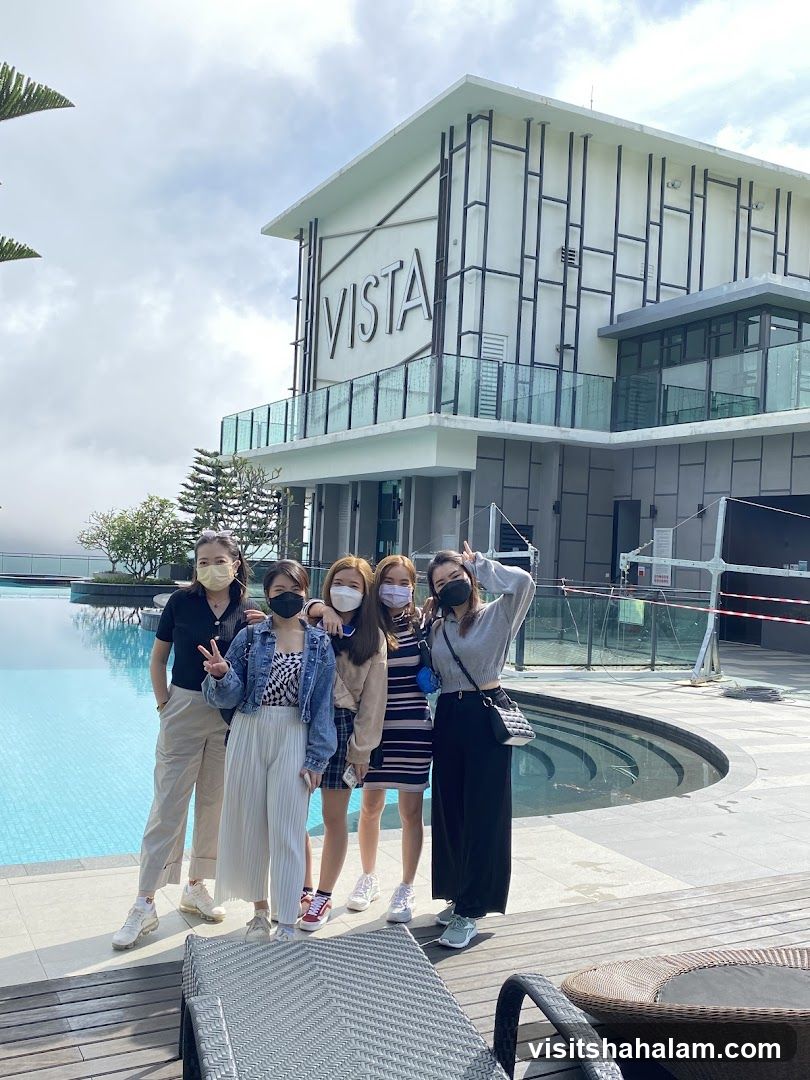 Group of friends by the pool with a building in the background