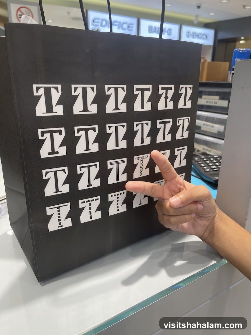 Black shopping bag with 'T' pattern