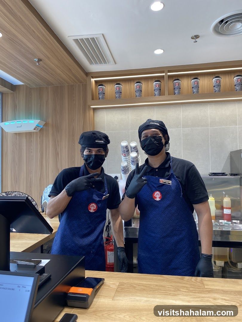 Two staff members behind a counter