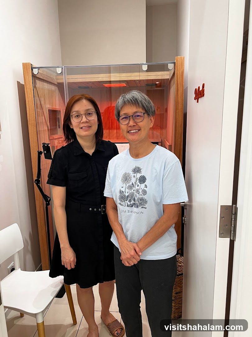 Two Women Posing in Front of an Infrared Sauna