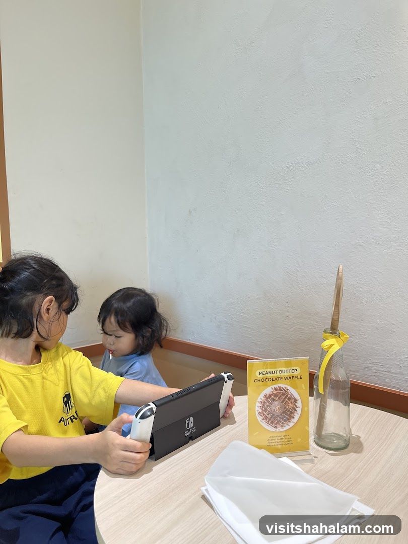 Children playing on a Nintendo Switch at a table