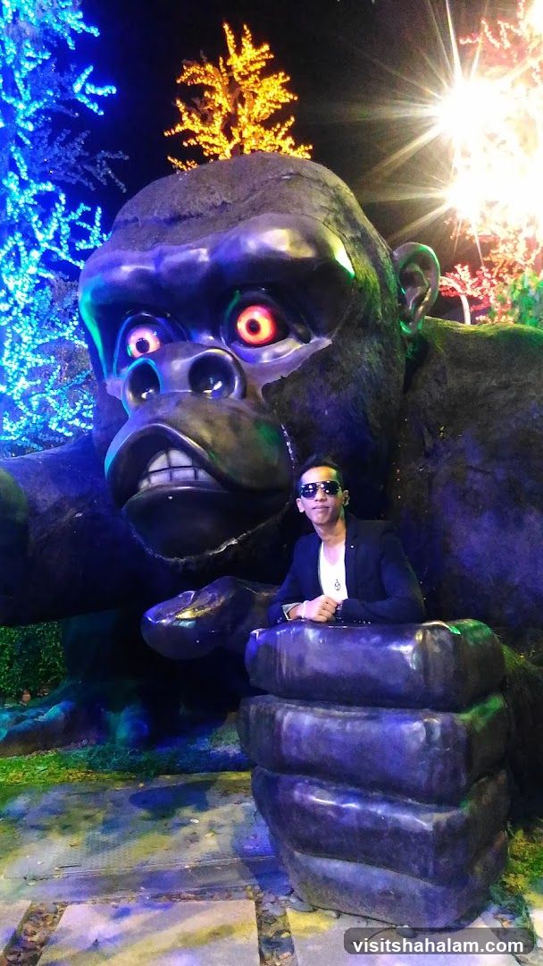 Man Poses with Giant Gorilla Statue