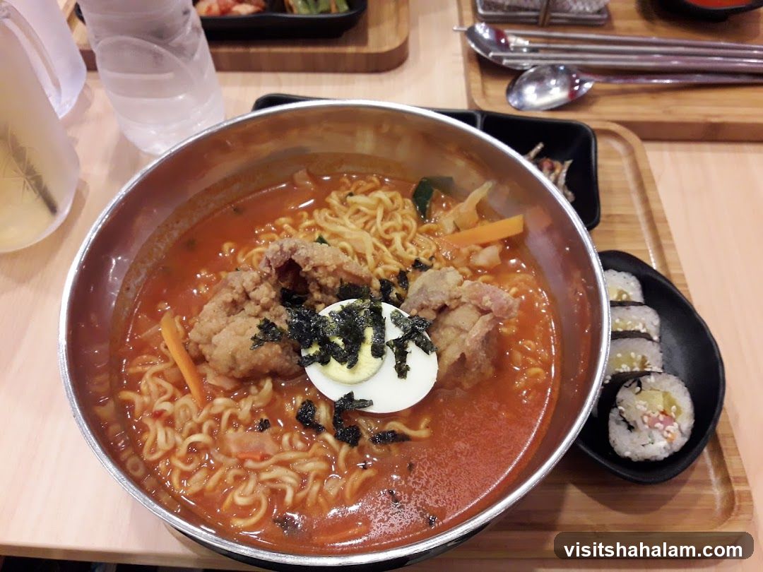 Korean Noodle Soup with Side of Sushi Rolls
