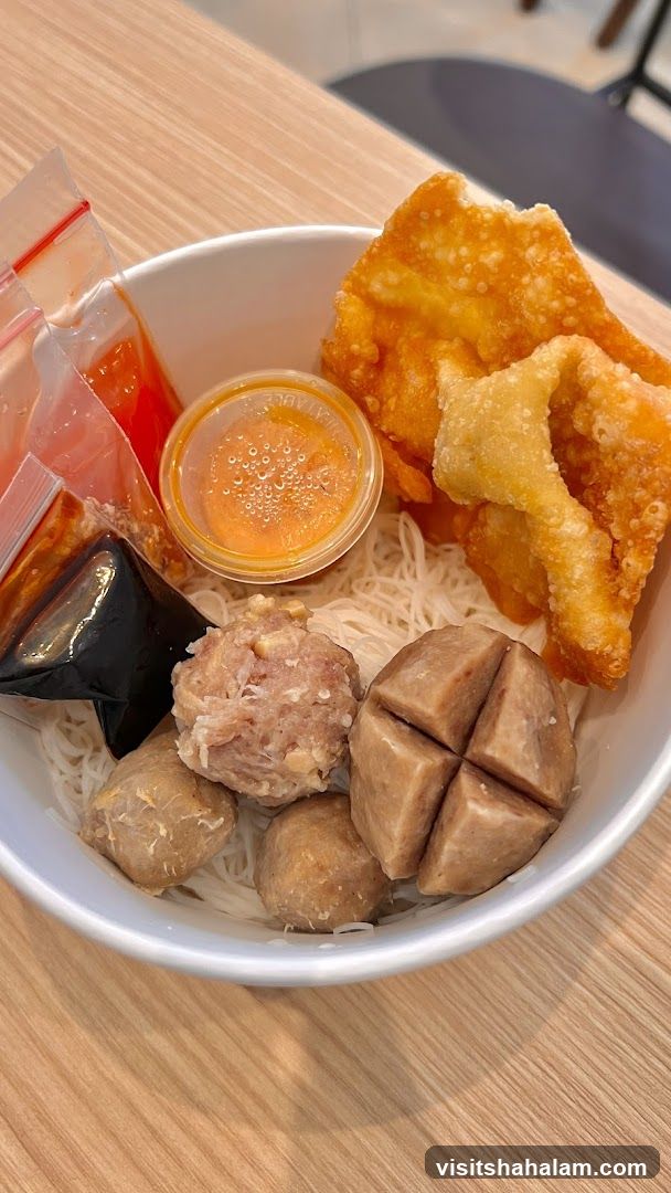 Bowl of Noodles with Meatballs and Fried Wontons