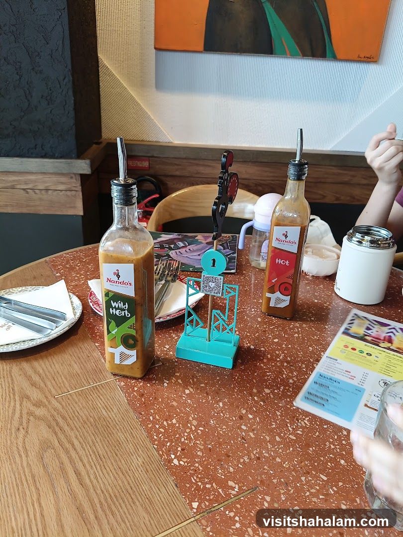 Table setting with Nando's sauces and menu