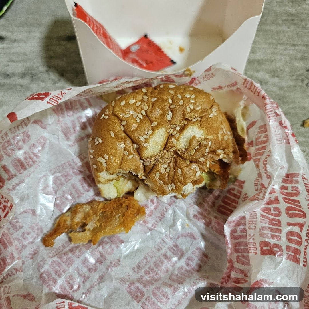 Half-eaten chicken burger