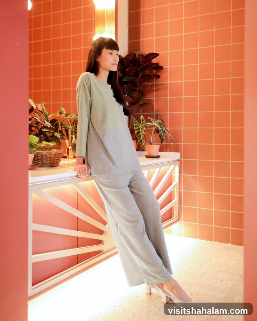 Woman in loungewear posing by a counter