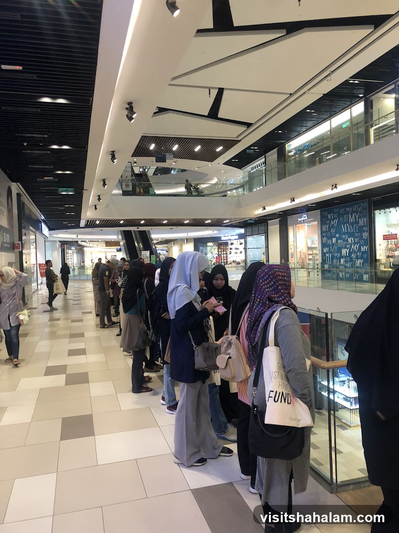 People queuing in a shopping mall