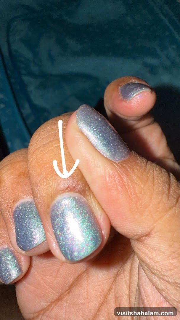 Close-up of a hand with holographic nail polish