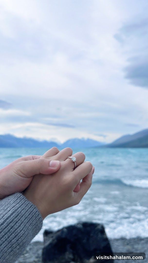 Couple holding hands with engagement ring