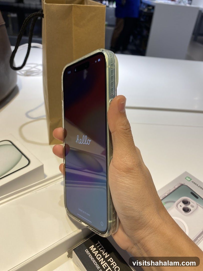Hand holding iPhone with hello screen