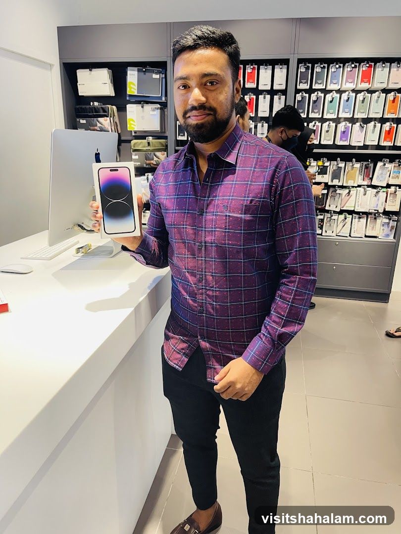 Man holding an iPhone box in a store