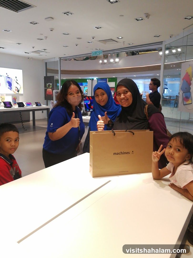 People posing with a shopping bag