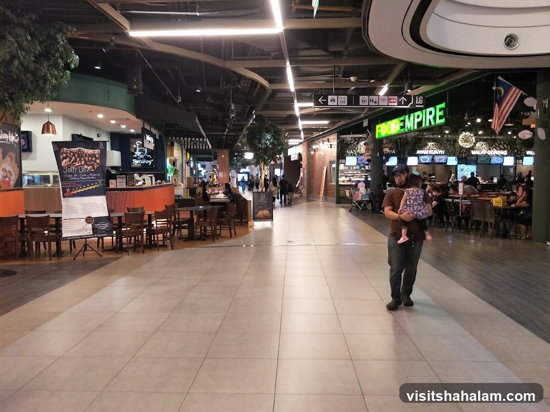 Food court with various stalls and seating areas