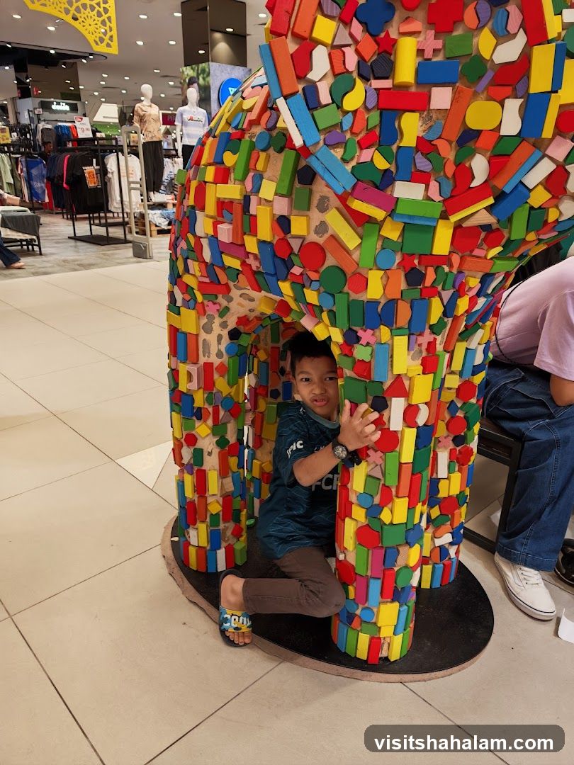 Child playing inside a colorful sculpture