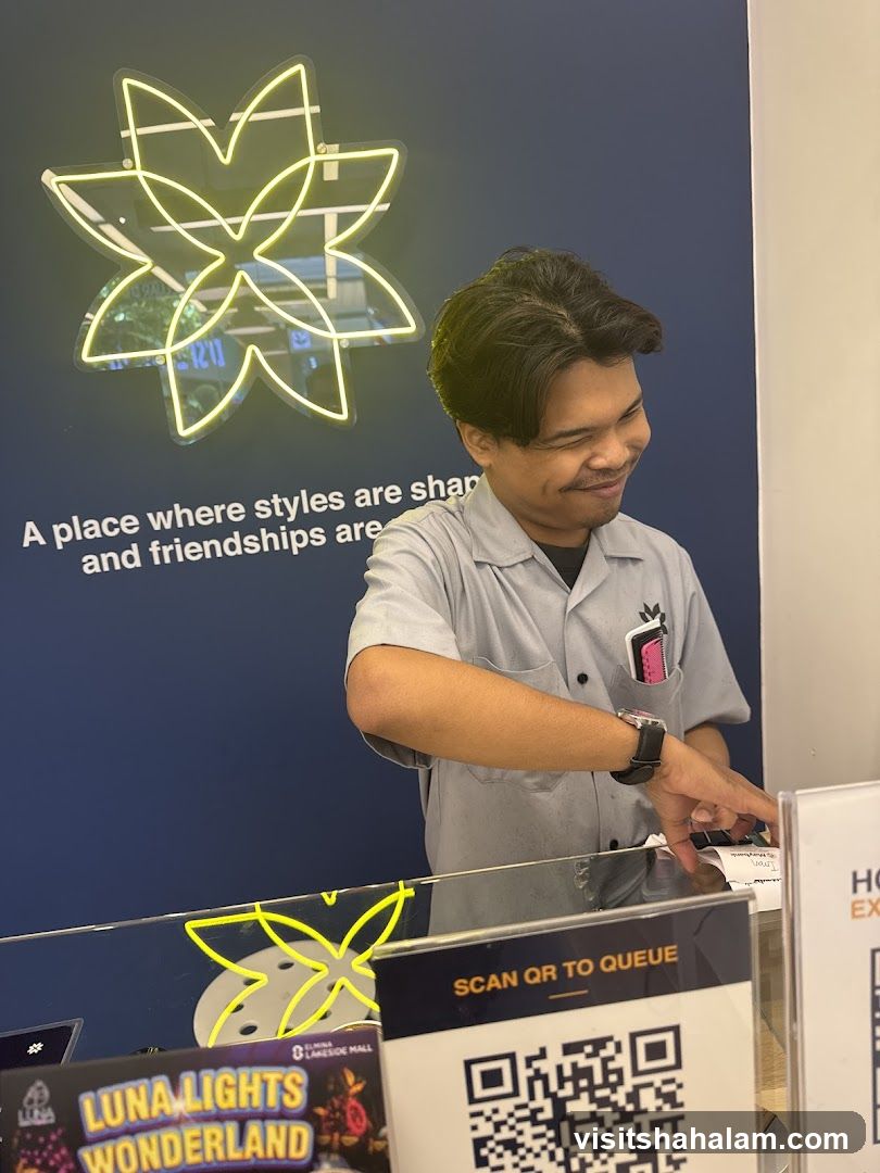 Man at a counter with neon sign