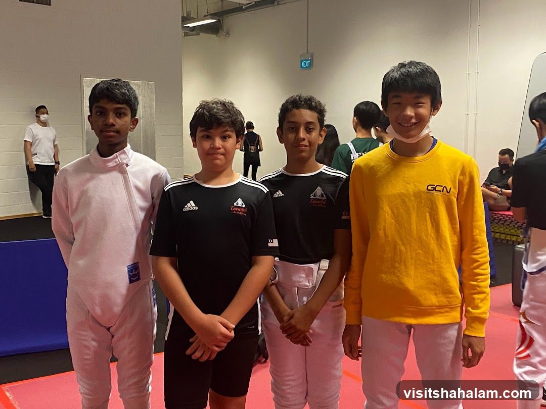 Four young fencers posing for a photo