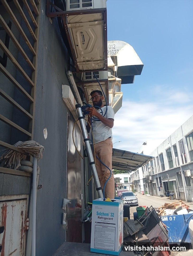 Man working on air conditioning units