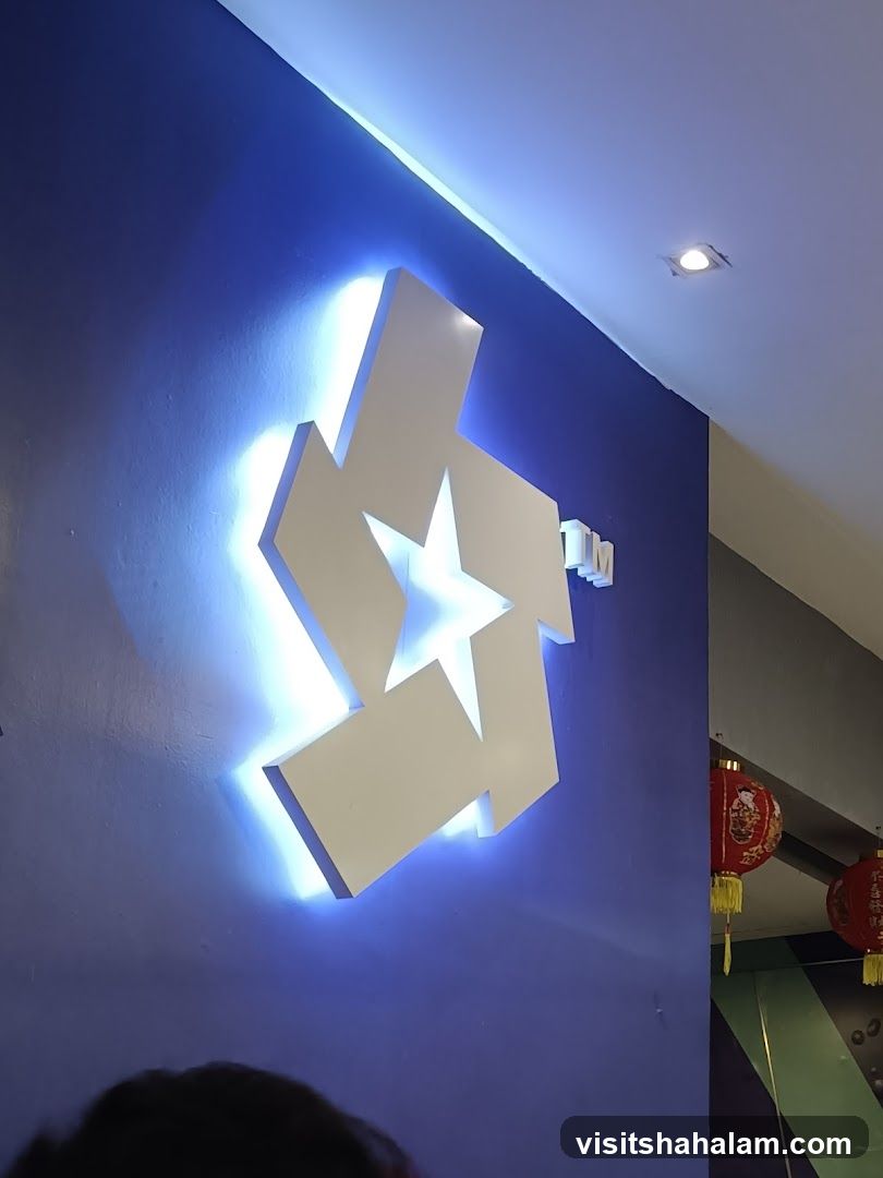Illuminated Logo on Blue Wall
