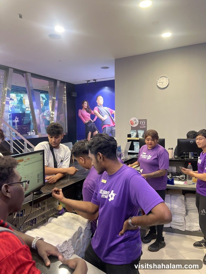 Gym Staff Assisting Customers