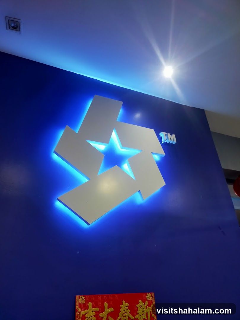 Illuminated Logo on Blue Wall