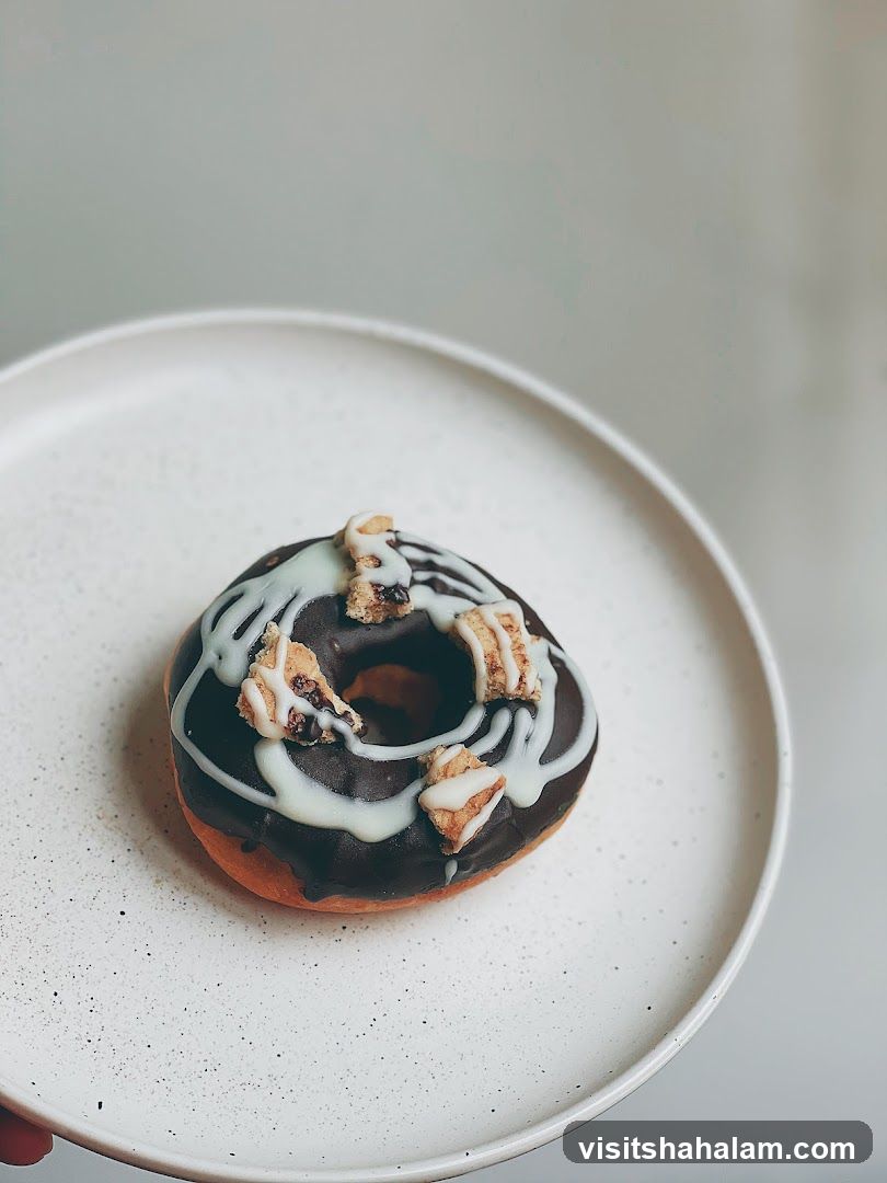 Chocolate Glazed Donut with White Drizzle and Toppings
